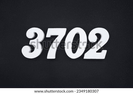 Black for the background. The number 3702 is made of white painted wood.