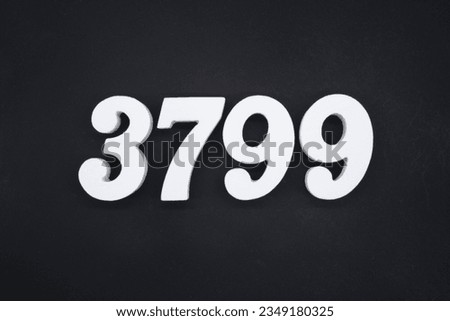 Black for the background. The number 3799 is made of white painted wood.
