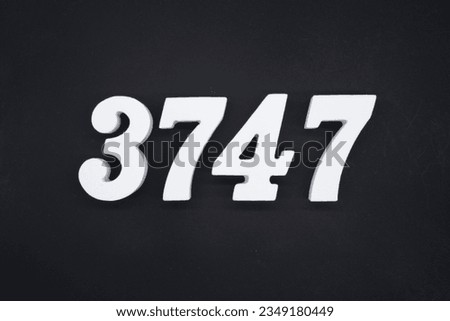 Black for the background. The number 3747 is made of white painted wood.