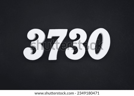 Black for the background. The number 3730 is made of white painted wood.