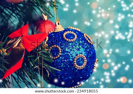 Toys on Christmas tree on Christmas lights background