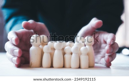 Risk management and assessment concept. Businessman protect employees from high risk, two hands block and protect wooden poeple corwd, Risk Management and Insurance Concept Royalty-Free Stock Photo #2349192115