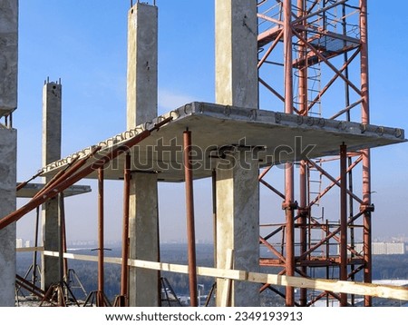 Precast concrete elements of the building at height. The frame of columns and Royalty-Free Stock Photo #2349193913