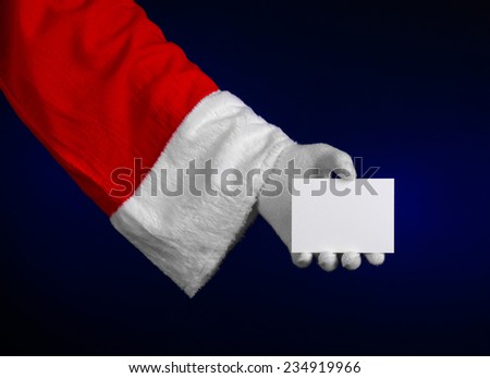 Santa Claus theme: Santa's hand holding a white card on a dark blue background