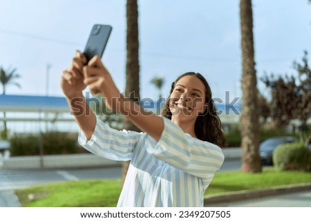 Young african american woman smiling confident making selfie by the smartphone at coffee shop terrace