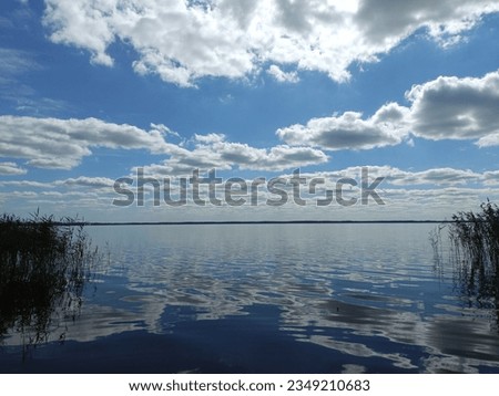 Rekyva lake during sunny day. Cloudy day. Wavy lake. White and gray colored clouds. Horizon over water. Rekyvos ezeras.