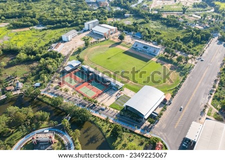 Aerial top view of soccer football sport recreation field ground, national stadium with university or college school campus buildings. Urban city town in Asia. Green court arena. Royalty-Free Stock Photo #2349225067