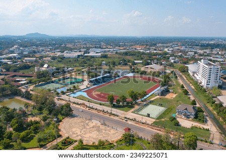 Aerial top view of soccer football sport recreation field ground, national stadium with university or college school campus buildings. Urban city town in Asia. Green court arena. Royalty-Free Stock Photo #2349225071