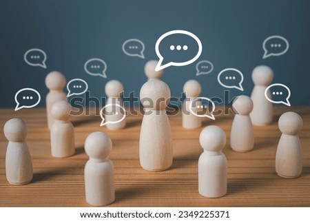 Wood figure with standing out from the crowd of different people, chatting concept, Wooden figurine with speech bubble, Unique human shape, Leadership,  Human resource.