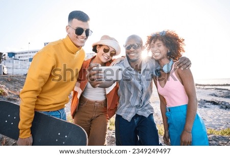 Selfie, smile and group of friends by the beach on summer vacation, adventure or weekend trip. Happy, diversity and young people having fun with skateboard and taking picture by the ocean on holiday.