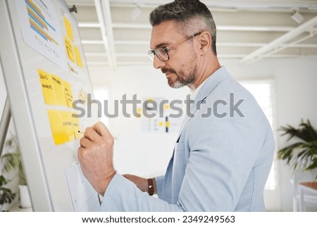Whiteboard, sticky notes and businessman planning in office brainstorming for a corporate project. Professional, analysis and mature male lawyer writing ideas or information for strategy in workplace Royalty-Free Stock Photo #2349249563