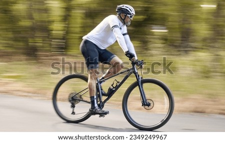 Nature, mountain bike or sports man travel, action and ride bicycle for triathlon challenge, journey or cardio. Cycling competition, fast motion blur or profile of cyclist training for race in France