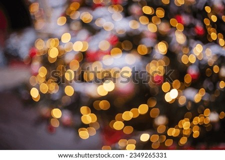 Unfocus are the beautiful blurry lights on the Christmas tree at the winter fair. Beautiful blurred background of Christmas holidays
