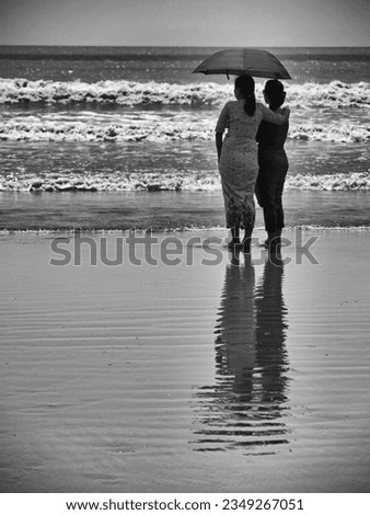 Monochrome two female friends looking out to sea, Setse beach, Myanmar. High quality photo