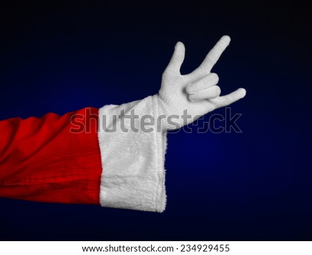 Santa Claus theme: Santa's hand showing gesture on a dark blue background