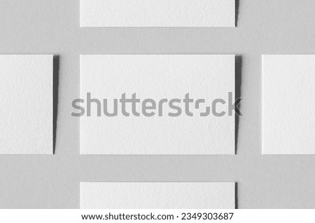 Textured business card mockup on a grey background. 85x55 mm.