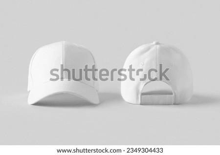 White baseball caps mockup on a grey background, front and back side. Royalty-Free Stock Photo #2349304433