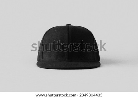 Black snapback cap mockup on a grey background, front view. Royalty-Free Stock Photo #2349304435