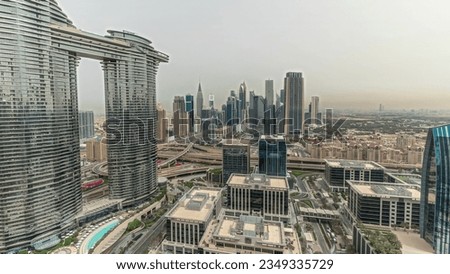 Pnorama showing futuristic Dubai Downtown and finansial district skyline aerial. Many towers and skyscrapers with traffic on streets. City walk district on a background