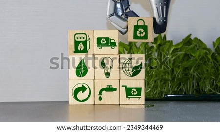 Crop person arranging small wooden blocks together to compose recycle emblem with eco friendly images