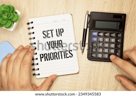 Set up your priorities sign on notepad on the white backgound.