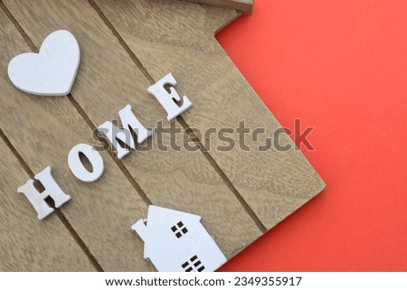 Sweet home sign. House wood with heart shape on wooden background