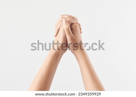 A woman's hand with separate symbolic movements on a white background, filming a high-definition studio