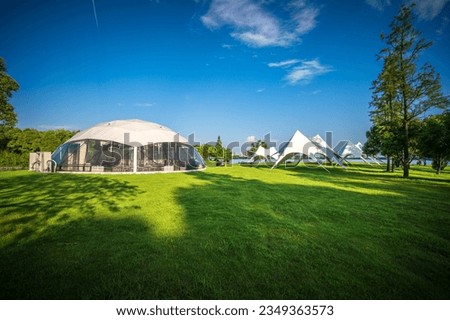 Tents for camping on the lawn on a sunny day, travel theme.