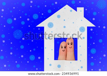 Finger art of a Happy couple. Family looking out of the window of the house out of paper. Falling snow background. 