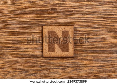 Capital Letter In Square Wooden Tiles - Letter N, On Wooden Background.