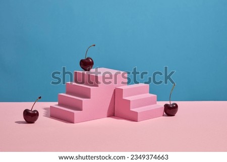 Blue background with blank space for product extracted from cherry presentation on pink stairway podium. Cherry is natural ingredients which has many beauty benefits. Front view Royalty-Free Stock Photo #2349374663