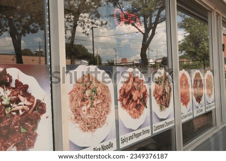 asian restaurant windows with neon open sign and pictures of meals dishes with caption writing beneath cantonese chowmein chicken fried rice chili chicken, entrance door, reflection sky trees
