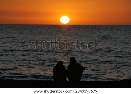 Enjoy the beauty of the sunset on the beach, with a silhouette effect