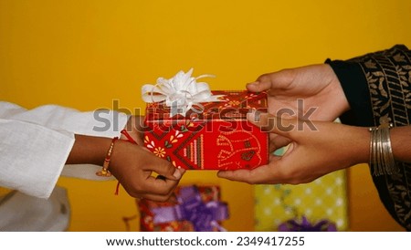 happy raksha bandhan (rakhi, rakshabandhan) concept. Indian brother giving gift to his sister