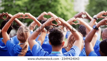 Diverse Young Charity Group Making Hearts Using Hands