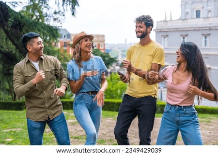 Group of multiethnic friends dancing in a park in the city at a friendship party