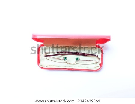 Glasses in an open red box case isolated on white background.