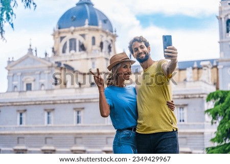 Tourist couple visiting Madrid city on summer vacation. Traveler vacation concept, taking a selfie Royalty-Free Stock Photo #2349429967