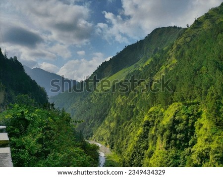 Beautiful land scape short of Northern Pakistan Khyber Pakhtunkhwa green meadows blue sky white clouds flowing river adventurous high mountain grass trees pure natural environments Royalty-Free Stock Photo #2349434329