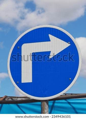 A traffic sign, turn right sign.