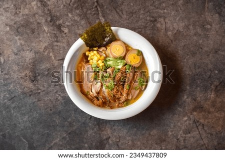Fresh steamed beef ramen noodle soup served with egg and pak choi, corn, nori, beef stock and spring onion. Japanese soup