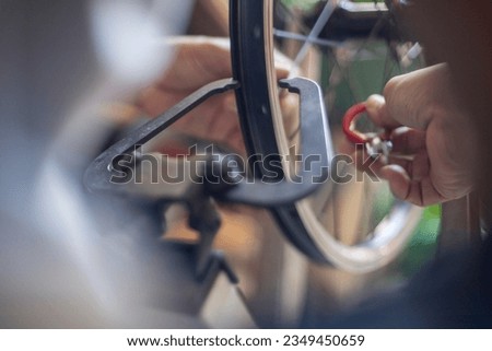 Repairing bicycle wheel on blur background