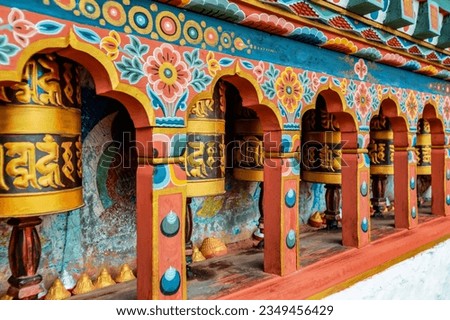 Bhutanese prayer wheel in closed up view. The prayer wheels text are used to accumulate wisdom and merit (good karma) and to purify negativeness (bad karma). Royalty-Free Stock Photo #2349456429