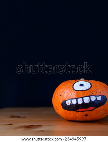 funny pumpkin decorated on black background