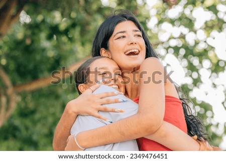 girls on the street smiling hugging