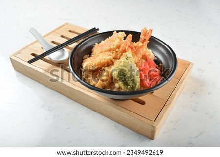 japanese deep fried crispy tempura prawn and vegetables rice in black bowl on wood tray white marble table background chef cook healthy poke bowl halal vegan food menu for cafe