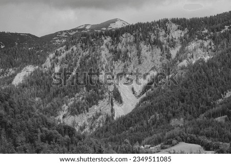 Alps mountains in stormy clouds, in black and white