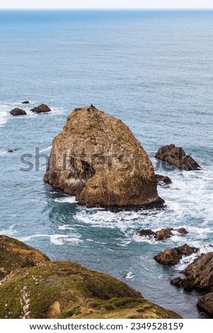 A photo taken of of the rocks sticking out the ocean at Nugget Point in the Caitlans, New Zealand