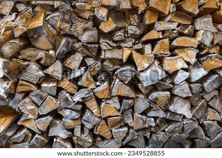 Winter preparation. Stacking Firewood.  Firewood background.Background of dry chopped firewood logs in a pile.