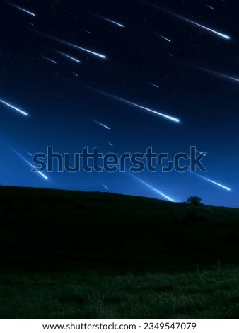 Star rain over the hill. Meteor shower in a clear sky. Stream of beautiful meteorites. Landscape with falling stars.